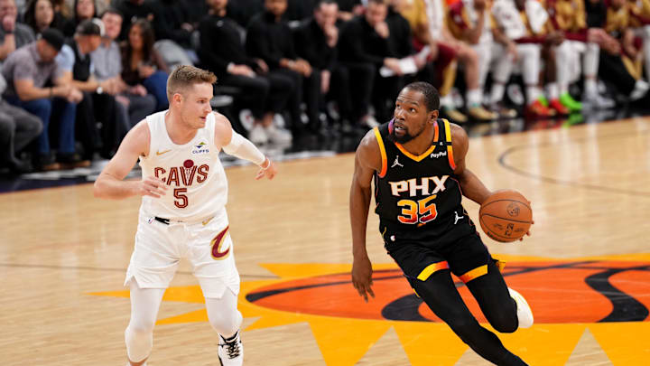 Mar 21, 2025; Phoenix, Arizona, USA; Phoenix Suns forward Kevin Durant (35) dribbles against Cleveland Cavaliers guard Sam Merrill (5) during the second half at Footprint Center. Mandatory Credit: Joe Camporeale-Imagn Images