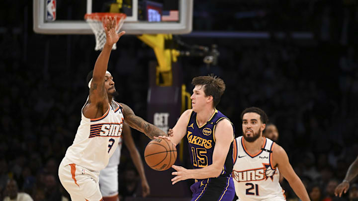 Oct 25, 2024; Los Angeles, California, USA; Los Angeles Lakers guard Austin Reaves (15) looks to pass against Phoenix Suns guard Bradley Beal (3) during the second half at Crypto.com Arena. Mandatory Credit: Jonathan Hui-Imagn Images