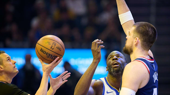 Apr 13, 2025; San Francisco, California, USA; Referee Kevin Scott (24), Golden State Warriors forward Draymond Green (23) and LA Clippers center Ivica Zubac (40) prepare for the opening tip-off of the game at Chase Center. Mandatory Credit: Robert Edwards-Imagn Images Apr 13, 2025; San Francisco, California, USA; Referee Kevin Scott (24), Golden State Warriors forward Draymond Green (23) and LA Clippers center Ivica Zubac (40) prepare for the opening tip-off of the game at Chase Center. Mandatory Credit: Robert Edwards-Imagn Images