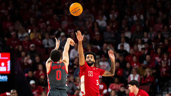 Feb 9, 2025; Lincoln, Nebraska, USA; Ohio State Buckeyes guard John Mobley Jr. (0) shoots a three point basket against Nebraska Cornhuskers guard Brice Williams (3) during the first half at Pinnacle Bank Arena. Mandatory Credit: Dylan Widger-Imagn Images