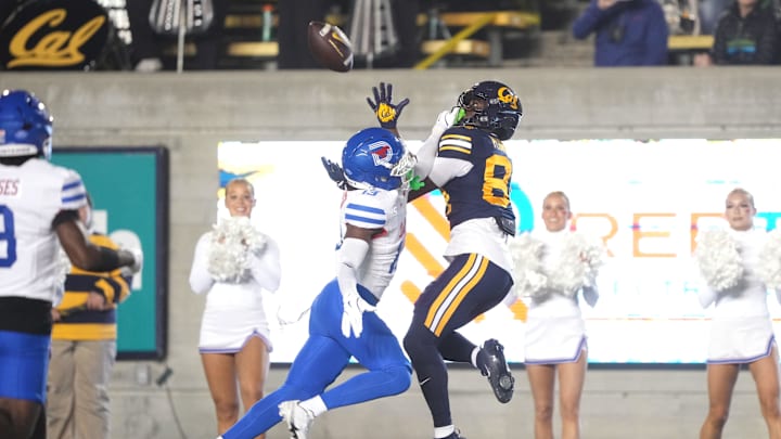 Nov 29, 2025; Berkeley, California, USA; California Golden Bears wide receiver Jaiven Plummer (center right) catches a touchdown pass against Southern Methodist Mustangs cornerback Jaelyn Davis-Robinson (center left) during the second quarter at California Memorial Stadium. Mandatory Credit: Darren Yamashita-Imagn Images
