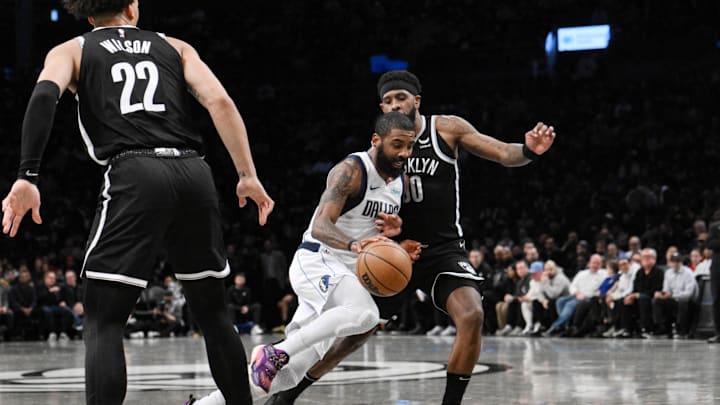 Feb 6, 2024; Brooklyn, New York, USA; Dallas Mavericks guard Kyrie Irving (11) drives to the basket as Brooklyn Nets forward Jalen Wilson (22) and forward Royce O'Neale (00) defend during the second quarter at Barclays Center. Mandatory Credit: John Jones-Imagn Images