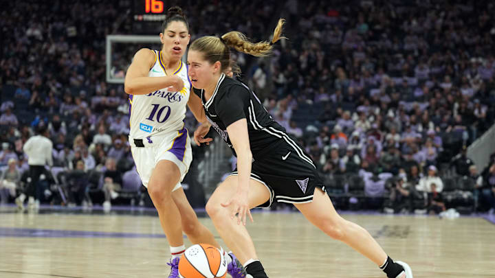 May 16, 2025; San Francisco, California, USA; Golden State Valkyries guard Kate Martin (center) dribbles against Los Angeles Sparks guard Kelsey Plum (10) during the third quarter at Chase Center. Mandatory Credit: Darren Yamashita-Imagn Images