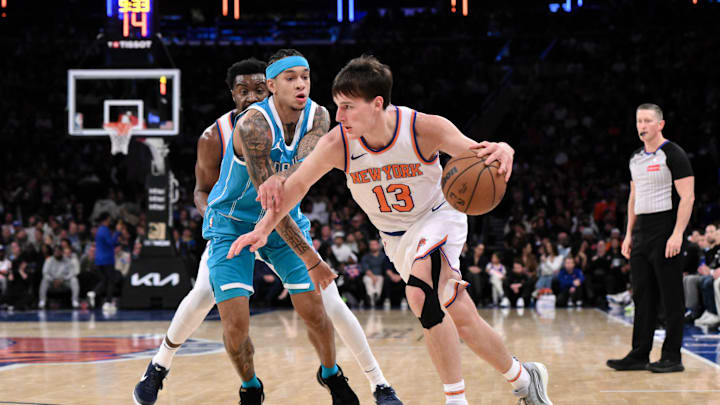 Oct 15, 2024; New York, New York, USA; New York Knicks guard Tyler Kolek (13) drives past Charlotte Hornets guard Tre Mann (23) during the first half at Madison Square Garden. Mandatory Credit: John Jones-Imagn Images