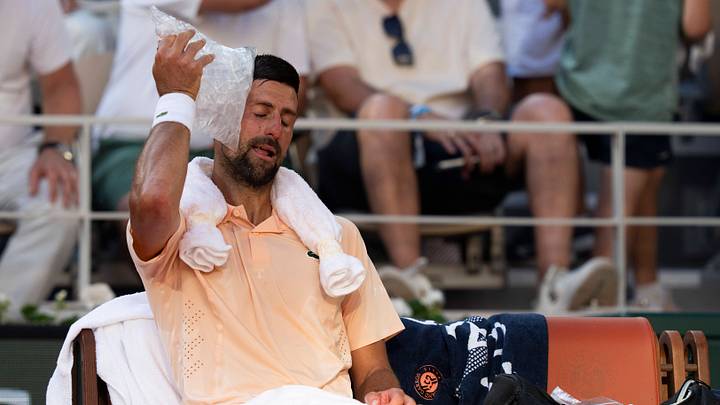 May 27, 2026; Paris, France; Novak Djokovic uses an ice bag and towel at a change of ends on day four at the 2026 French Open. Mandatory Credit: Susan Mullane-Imagn Images