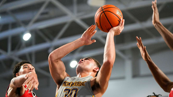 Montverde Academy Eagles guard Dante Allen (30) shoots a lay up while usrrounded by Archbishop Carroll Patriots defenders during the fourth quarter of the first round of the 51st annual City of Palms Classic at Suncoast Credit Union Arena in Fort Myers, Fla., on Wednesday, Dec. 18, 2024.