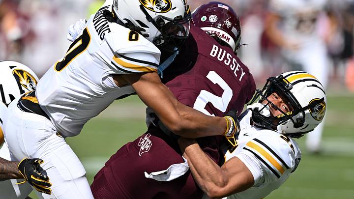 Missouri Tigers wide receiver Joshua Manning (0) and safety Joseph Charleston (28) tackle Texas A&M Aggies wide receiver Terry Bussey (2) in the first quarter at Kyle Field.