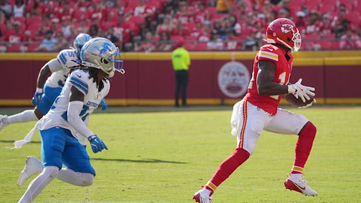 Aug 17, 2024; Kansas City, Missouri, USA; Kansas City Chiefs wide receiver Cornell Powell (14) catches a pass and runs for a touchdown as Detroit Lions cornerback Steven Gilmore (24) chases during the second half at GEHA Field at Arrowhead Stadium. Mandatory Credit: Denny Medley-Imagn Images
