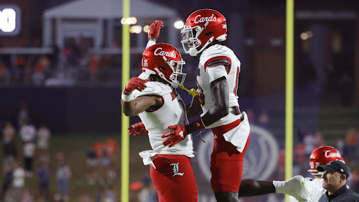 Oct 12, 2024; Charlottesville, Virginia, USA; Louisville Cardinals tight end Jamari Johnson (11) celebrates with Cardinals tight end Jaleel Skinner (88) after scoring the game winning touchdown against the Virginia Cavaliers during the second half at Scott Stadium. Mandatory Credit: Amber Searls-Imagn Images