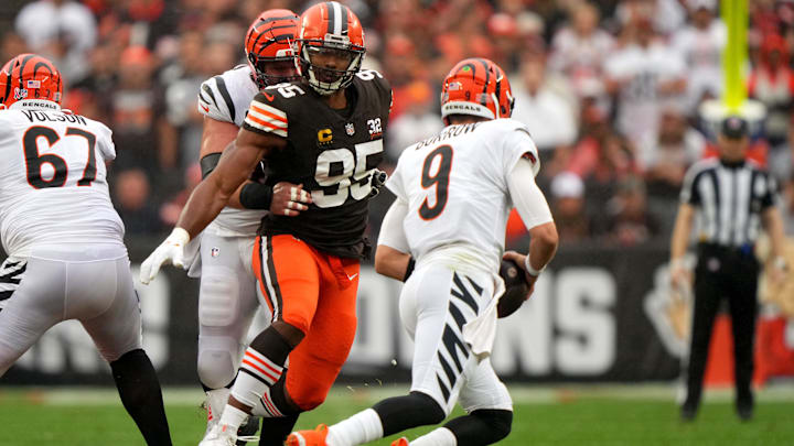 Cleveland Browns defensive end Myles Garrett (95) pressured Cincinnati Bengals quarterback Joe Burrow (9) as Cincinnati Bengals center Ted Karras (64) blocks in the first quarter of an NFL football game between the Cincinnati Bengals and Cleveland Browns, Sunday, Sept. 10, 2023, at Cleveland Browns Stadium in Cleveland.