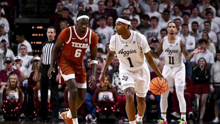 Jan 4, 2025; College Station, Texas, USA; Texas A&M Aggies guard Zhuric Phelps (1) dribbles the ball as Texas Longhorns forward Arthur Kaluma (6) defends during the second half at Reed Arena. The Aggies defeated the Longhorns 80-60. Mandatory Credit: Maria Lysaker-Imagn Images 