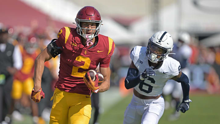 USC's Duce Robinson runs with the ball as Penn State's Zakee Wheatley pursues him.