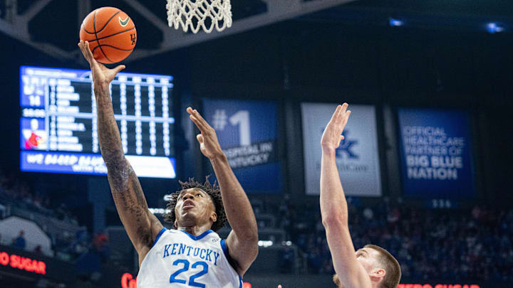 Kentucky Wildcats center Amari Williams (22) goes for a layup against Louisville Cardinals forward Noah Waterman (93) during their game on Saturday, Dec. 14, 2024 at Rupp Arena in Lexington, Ky.