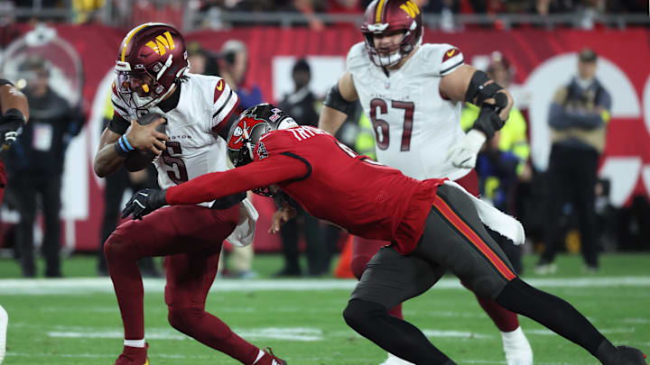 Jan 12, 2025; Tampa, Florida, USA; Washington Commanders quarterback Jayden Daniels (5) scrambles against Tampa Bay Buccaneers linebacker Joe Tryon-Shoyinka (9) during the second quarter of a NFC wild card playoff at Raymond James Stadium. Mandatory Credit: Kim Klement Neitzel-Imagn Images Jan 12, 2025; Tampa, Florida, USA; Washington Commanders quarterback Jayden Daniels (5) scrambles against Tampa Bay Buccaneers linebacker Joe Tryon-Shoyinka (9) during the second quarter of a NFC wild card playoff at Raymond James Stadium. Mandatory Credit: Kim Klement Neitzel-Imagn Images