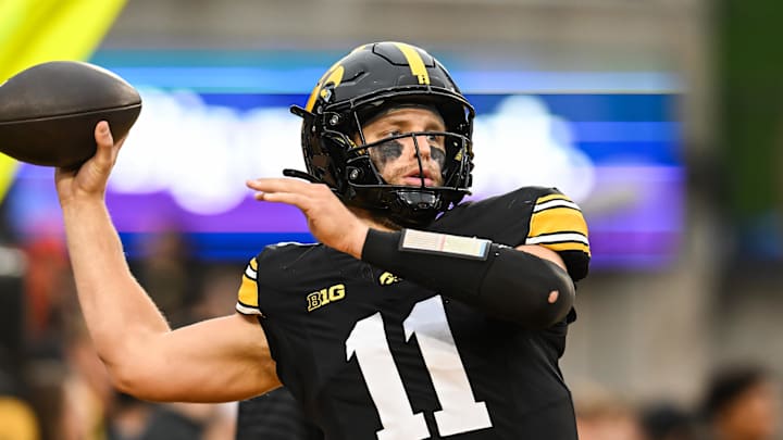 Oct 18, 2025; Iowa City, Iowa, USA; Iowa Hawkeyes quarterback Mark Gronowski (11) warms up before the game against the Penn State Nittany Lions at Kinnick Stadium. Mandatory Credit: Jeffrey Becker-Imagn Images