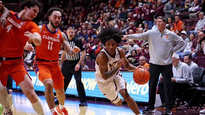 Jan 25, 2025; Blacksburg, Virginia, USA; Virginia Tech Hokies guard Ben Hammond (11) drives to the basket against Clemson Tigers guard Jaeden Zackery (11) during the first half at Cassell Coliseum. Mandatory Credit: Peter Casey-Imagn Images