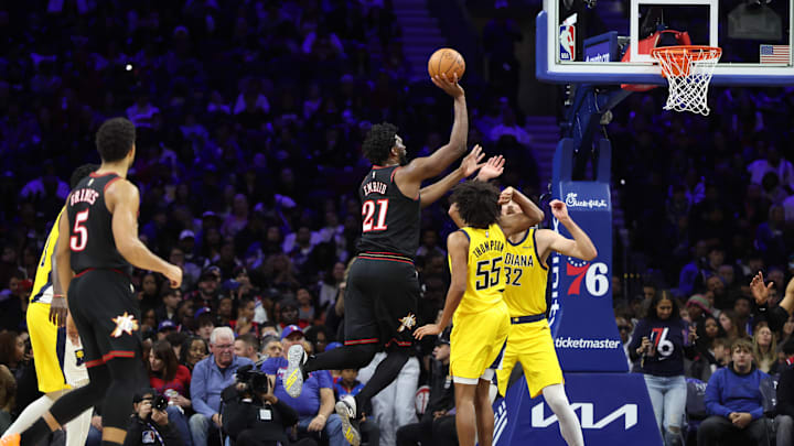 Dec 12, 2025; Philadelphia, Pennsylvania, USA; Philadelphia 76ers center Joel Embiid (21) drives for a shot against Indiana Pacers center Jay Huff (32) and guard Ethan Thompson (55) during the third quarter at Xfinity Mobile Arena. Mandatory Credit: Bill Streicher-Imagn Images Dec 12, 2025; Philadelphia, Pennsylvania, USA; Philadelphia 76ers center Joel Embiid (21) drives for a shot against Indiana Pacers center Jay Huff (32) and guard Ethan Thompson (55) during the third quarter at Xfinity Mobile Arena. Mandatory Credit: Bill Streicher-Imagn Images