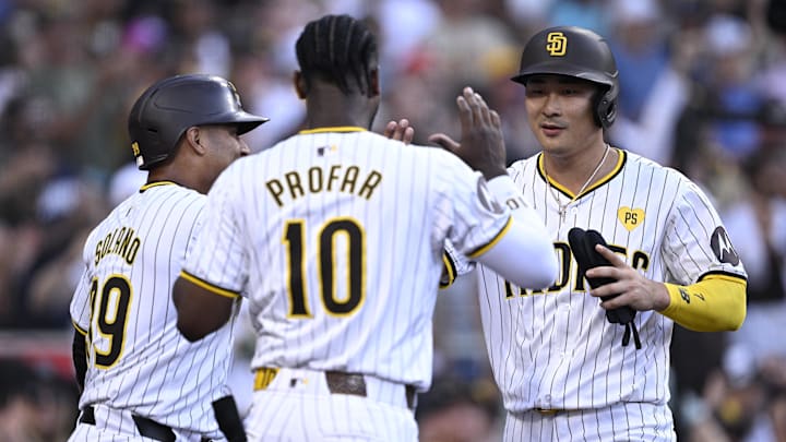 Jun 24, 2024; San Diego, California, USA; San Diego Padres shortstop Ha-Seong Kim (7) is congratulated by designated hitter Donovan Solano (39) and left fielder Jurickson Profar (10) after scoring a run against the Washington Nationals during the second inning at Petco Park. Mandatory Credit: Orlando Ramirez-Imagn Images