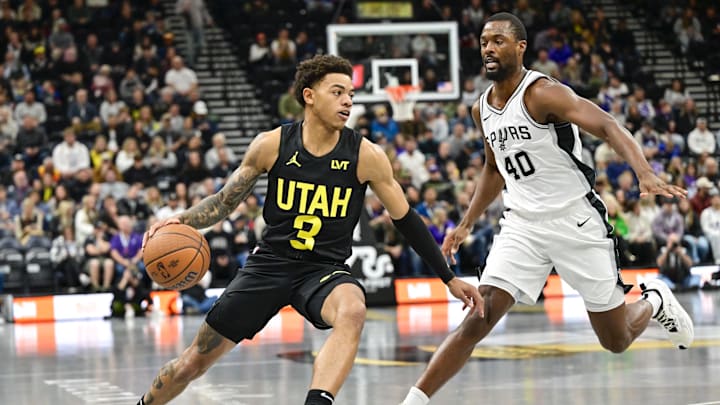 Nov 26, 2024; Salt Lake City, Utah, USA; Utah Jazz guard Keyonte George (3) dribbles around San Antonio Spurs forward Harrison Barnes (40) during the first half at the Delta Center. Mandatory Credit: Christopher Creveling-Imagn Images