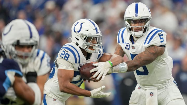 Indianapolis Colts quarterback Anthony Richardson (5) hands the ball off to Indianapolis Colts running back Jonathan Taylor (28) on Sunday, Dec. 22, 2024, during a game against the Tennessee Titans at Lucas Oil Stadium in Indianapolis.