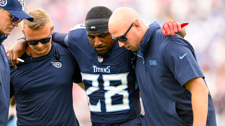 Tennessee Titans trainers carry safety Quandre Diggs off after his injury against the New England Patriots.