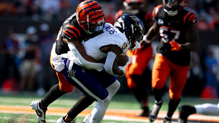 Cincinnati Bengals cornerback DJ Turner II (20) tackle Baltimore Ravens wide receiver Zay Flowers (4) in the fourth quarter of the NFL game at Paycor Stadium in Cincinnati on Sunday, Oct. 6, 2024.