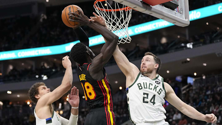 Mar 30, 2025; Milwaukee, Wisconsin, USA;  Milwaukee Bucks guard Pat Connaughton (24) defends Atlanta Hawks forward Mouhamed Gueye (18) during the third quarter at Fiserv Forum. Mandatory Credit: Jeff Hanisch-Imagn Images