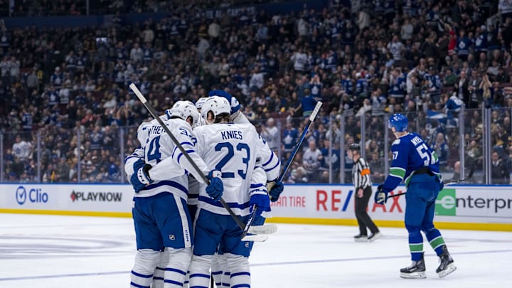 Feb 8, 2025; Vancouver, British Columbia, CAN; Toronto Maple Leafs forward Auston Matthews (34) and forward Matthew Knies (23) and defenseman Oliver Ekman-Larsson (95) celebrate after a goal by and defenseman Morgan Rielly (44) in the second period against the Vancouver Canucks at Rogers Arena. Mandatory Credit: Bob Frid-Imagn Images