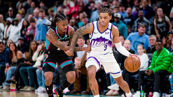 Dec 12, 2025; Memphis, Tennessee, USA; Utah Jazz guard Keyonte George (3) drives past defender Memphis Grizzlies point guard Ja Morant (12) in the second half at FedExForum. Mandatory Credit: Matthew Smith-Imagn Images Dec 12, 2025; Memphis, Tennessee, USA; Utah Jazz guard Keyonte George (3) drives past defender Memphis Grizzlies point guard Ja Morant (12) in the second half at FedExForum. Mandatory Credit: Matthew Smith-Imagn Images