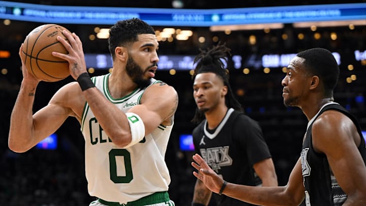 Feb 12, 2025; Boston, Massachusetts, USA; Boston Celtics forward Jayson Tatum (0) drives to the basket against San Antonio Spurs guard De'Aaron Fox (4) during the third quarter at the TD Garden. Mandatory Credit: Brian Fluharty-Imagn Images