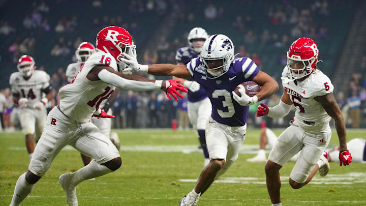 Kansas State Dylan Edwards (3) stiff arms Rutgers cornerback Jesse Ofurie on his way to the go-ahead touchdown during second half of the Rate Bowl at Chase Field on Dec. 26, 2024, in Phoenix.