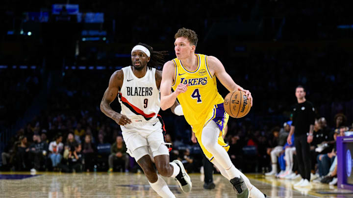 Oct 27, 2025; Los Angeles, California, USA; Los Angeles Lakers forward Dalton Knecht (4) drives the ball during the second half against the Portland Trail Blazers at Crypto.com Arena. Mandatory Credit: William Liang-Imagn Images
