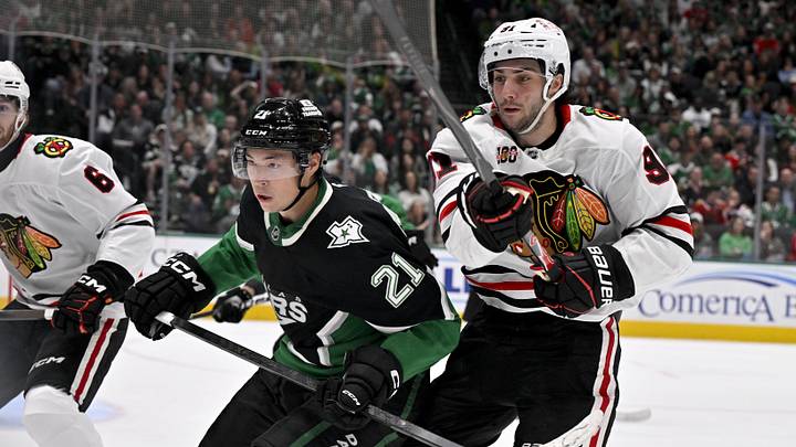 Mar 8, 2026; Dallas, Texas, USA; Dallas Stars left wing Jason Robertson (21) and Chicago Blackhawks center Frank Nazar (91) chase the puck during the second period at the American Airlines Center. Mandatory Credit: Jerome Miron-Imagn Images