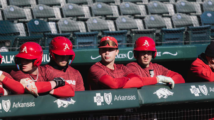 Arkansas baseball players along the dugout in the first spring scrimmage at Baum-Walker Stadium
