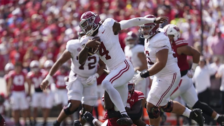 Sep 14, 2024; Madison, Wisconsin, USA;  Alabama Crimson Tide quarterback Jalen Milroe (4) rushes with the football during the third quarter against the Wisconsin Badgers at Camp Randall Stadium. Mandatory Credit: Jeff Hanisch-Imagn Images