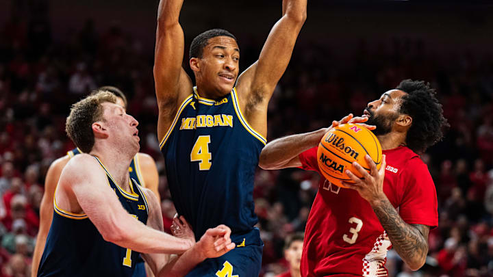 Feb 24, 2025; Lincoln, Nebraska, USA; Nebraska Cornhuskers guard Brice Williams (3) drives against Michigan Wolverines guard Nimari Burnett (4) and center Danny Wolf (1) during the first half at Pinnacle Bank Arena. Mandatory Credit: Dylan Widger-Imagn Images
