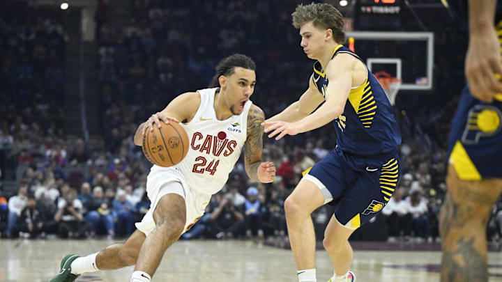 Apr 13, 2025; Cleveland, Ohio, USA; Cleveland Cavaliers forward Jaylon Tyson (24) dribbles beside Indiana Pacers forward Johnny Furphy (12) in the first quarter at Rocket Arena. Mandatory Credit: David Richard-Imagn Images