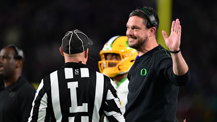 Oct 18, 2024; West Lafayette, Indiana, USA; Oregon Ducks head coach Dan Lanning holds his hand up and smiles while talking to a referee during the first quarter at Ross-Ade Stadium. Mandatory Credit: Marc Lebryk-Imagn Images