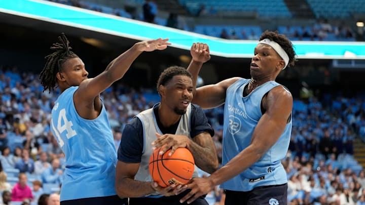 Oct 12, 2024; Chapel Hill, NC, USA;  North Carolina Tar Heels forward Ty Claude (0) with the ball as guard Russell Hawkins (14) and forward Ven-Allen Lubin (22) defend in the second half at the Dean E. Smith Center. Mandatory Credit: Bob Donnan-Imagn Images