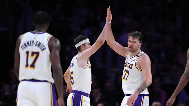 Mar 16, 2025; Los Angeles, California, USA; Los Angeles Lakers guard Luka Doncic (77) and guard Austin Reaves (15) celebrate against the Phoenix Suns in the second half at Crypto.com Arena. Mandatory Credit: Kirby Lee-Imagn Images