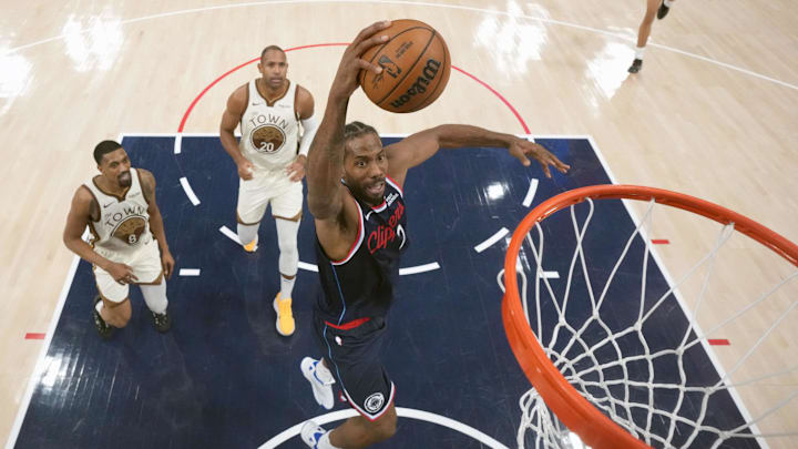 Jan 5, 2026; Inglewood, California, USA; LA Clippers forward Kawhi Leonard (2) dunks the ball against the Golden State Warriors in the second half at Intuit Dome. Mandatory Credit: Kirby Lee-Imagn Images