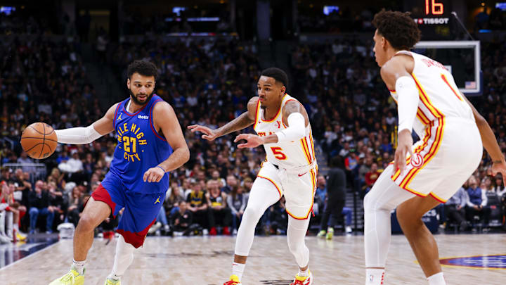 Apr 6, 2024; Denver, Colorado, USA; Denver Nuggets guard Jamal Murray (27) dribbles past Atlanta