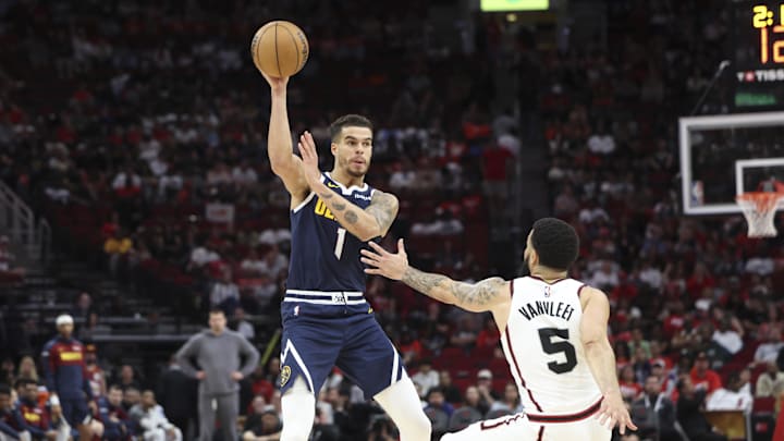 Mar 23, 2025; Houston, Texas, USA; Denver Nuggets forward Michael Porter Jr. (1) passes the ball as Houston Rockets guard Fred VanVleet (5) defends during the fourth quarter at Toyota Center. Mandatory Credit: Troy Taormina-Imagn Images