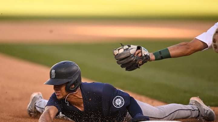 Seattle Mariners designated hitter Leo Rivas (76) steals third base against Oakland Athletics third baseman Tristan Gray (16) in the eighth inning at Oakland-Alameda County Coliseum in 2024.