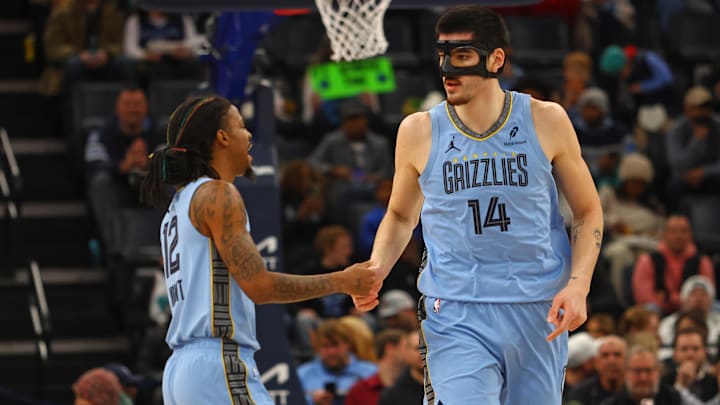 Jan 22, 2025; Memphis, Tennessee, USA; Memphis Grizzlies center Zach Edey (14) talks with guard Ja Morant (12) during the first quarter against the Charlotte Hornets at FedExForum. Mandatory Credit: Petre Thomas-Imagn Images Jan 22, 2025; Memphis, Tennessee, USA; Memphis Grizzlies center Zach Edey (14) talks with guard Ja Morant (12) during the first quarter against the Charlotte Hornets at FedExForum. Mandatory Credit: Petre Thomas-Imagn Images