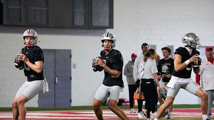 Ohio State Buckeyes quarterbacks Julian Sayin (10), Tavien St. Clair (9) and Lincoln Kienholz (3) look to throw during spring football practice at the Woody Hayes Athletic Center on Wednesday, March 19, 2025 in Columbus, Ohio.