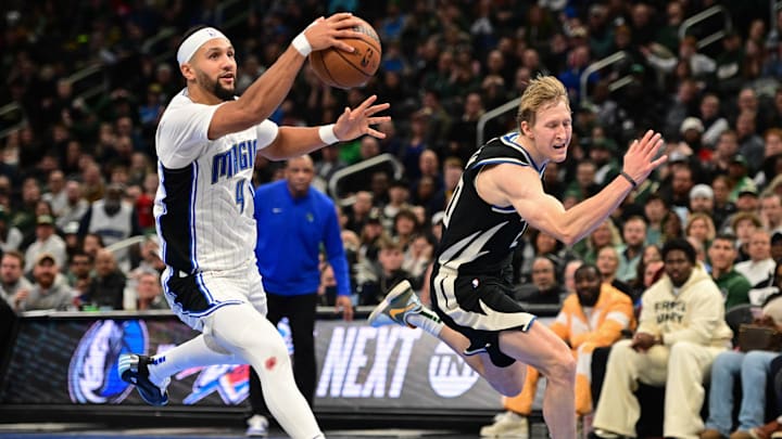 Dec 10, 2024; Milwaukee, Wisconsin, USA;  Orlando Magic guard Jalen Suggs (4) drives for the basket against Milwaukee Bucks guard AJ Green (20) in the fourth quarter at Fiserv Forum. Mandatory Credit: Benny Sieu-Imagn Images