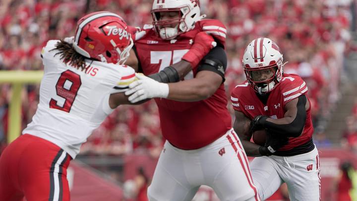 Wisconsin running back Dilin Jones (7) follows a block by offensive lineman Emerson Mandell (75) during the first quarter of their game against Maryland Saturday, September 20, 2025 at Camp Randall Stadium in Madison, Wisconsin.