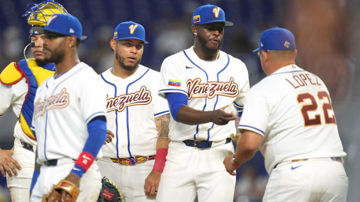 Mar 6, 2026; Miami, FL, United States;  Venezuela pitcher Luinder Avila (58) hands the ball to manager Omar López (22) in the sixth inning at loanDepot Park. Mandatory Credit: Jim Rassol-Imagn Images
