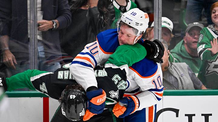 Mar 12, 2026; Dallas, Texas, USA; Edmonton Oilers center Trent Frederic (10) fights with Dallas Stars center Justin Hryckowian (49) during the game between the Stars and the Oilers at the American Airlines Center. Mandatory Credit: Jerome Miron-Imagn Images